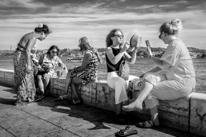A local street seller sells jewellery to tourists in Lisbon