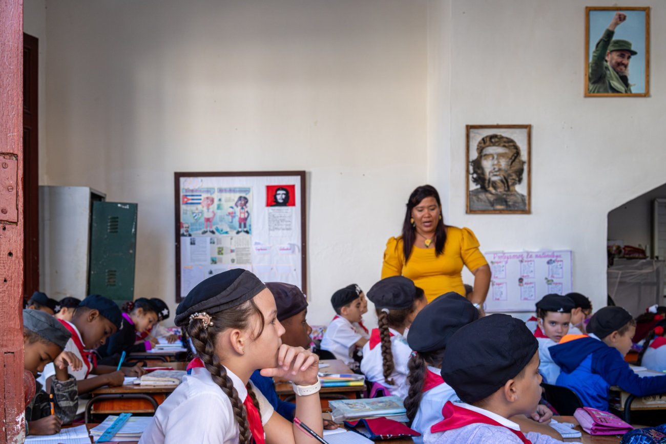 Cuba Street Photography Roadtrp | 14 Day Guide with Mark Seymour 8 “Students in a Cuban primary school concentrating on their work as their teacher gives instructions, with portraits of Che Guevara and Fidel Castro on the wall.”
