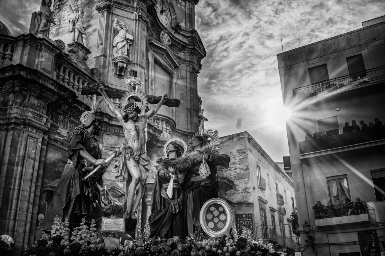 Inside the Misteri di Trapani: Documenting Sicily’s Living Tradition 10 The Crucifixion sacred group emerges from the Church of the Anime Sante during the Misteri di Trapani procession as sunlight breaks through the buildings in Trapani, Sicily.