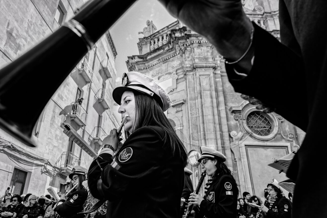 Inside the Misteri di Trapani: Documenting Sicily’s Living Tradition 5 Young musicians perform outside the Church of the Anime Sante before the Misteri di Trapani procession begins in Trapani, Sicily.