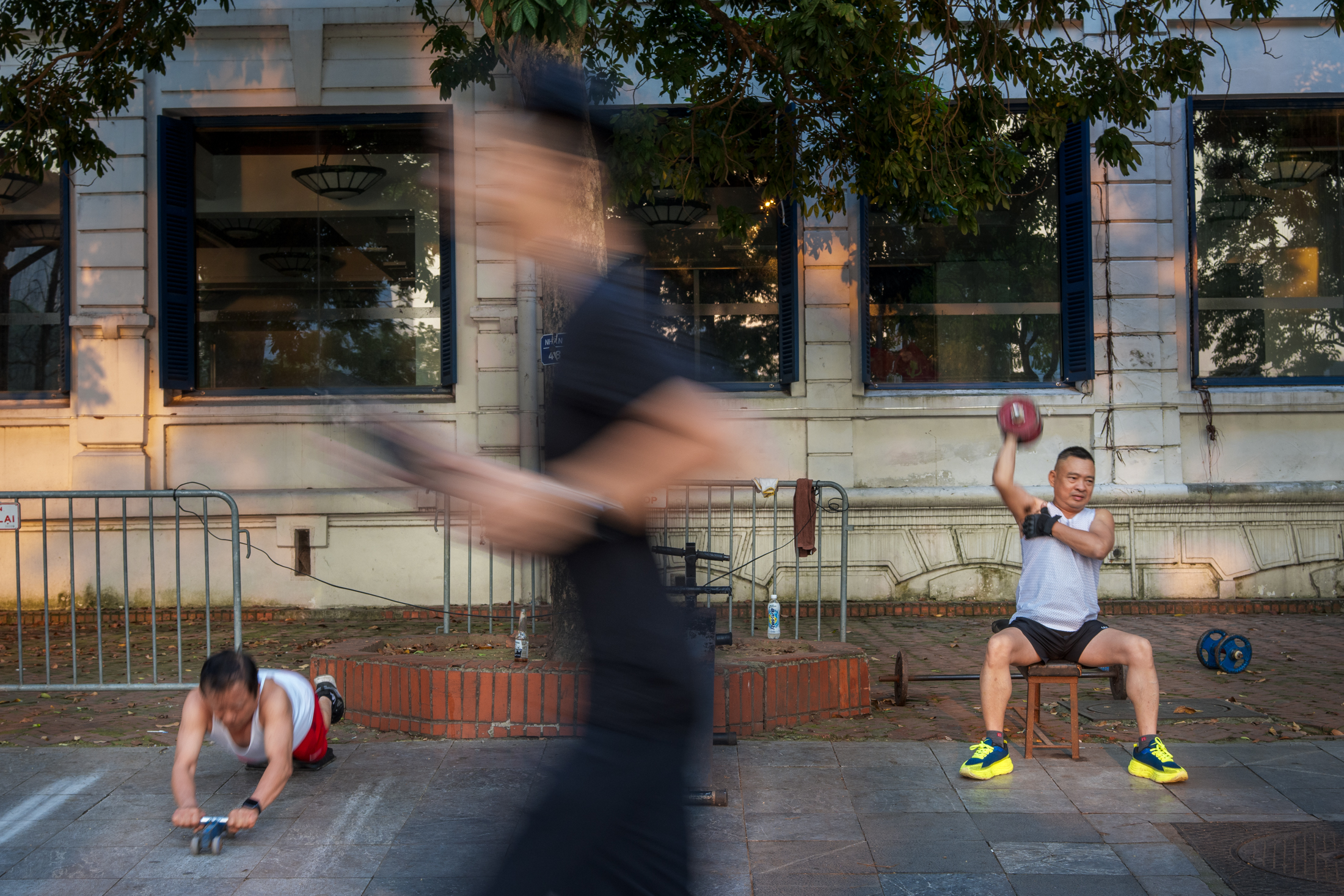 Northern Vietnam Photography: A Photographer’s Journey Beyond the Tourist Trail 23 Local residents exercise beside Hoan Kiem Lake in Hanoi as a blurred passer-by moves through the foreground.