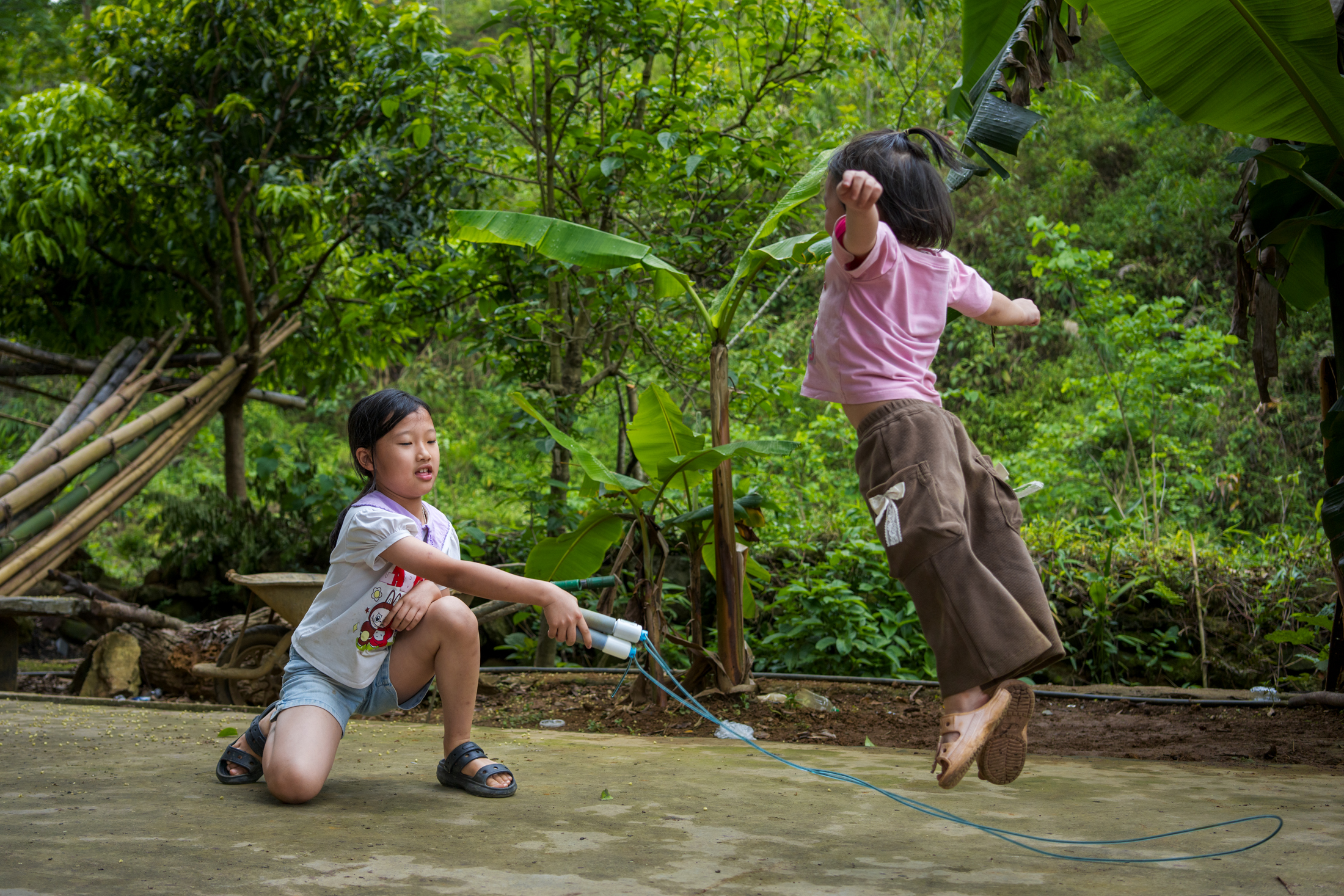 Northern Vietnam Photography: A Photographer’s Journey Beyond the Tourist Trail 27 Two young girls play with a skipping rope outside their home in a mountain village in northern Vietnam.