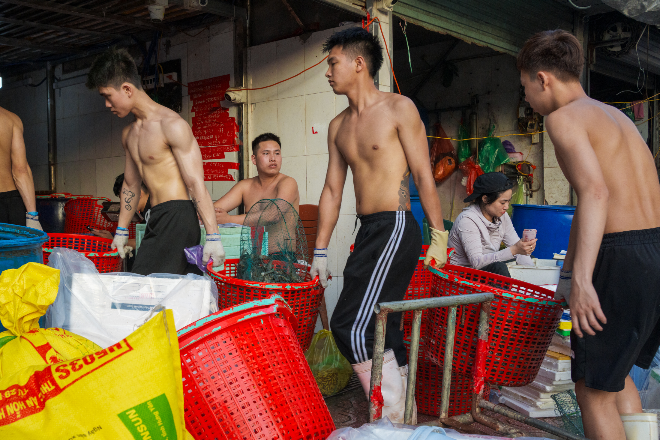 Northern Vietnam Photography: A Photographer’s Journey Beyond the Tourist Trail 16 Workers carry baskets through the seafood section of Long Bien Market in Hanoi, Vietnam, during the early morning trading hours.