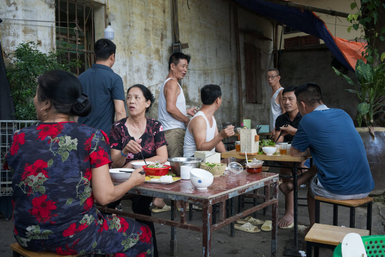 Northern Vietnam Photography: A Photographer’s Journey Beyond the Tourist Trail 2 Vietnamese families and neighbours sharing an evening meal together in a residential courtyard in Hanoi, Vietnam.