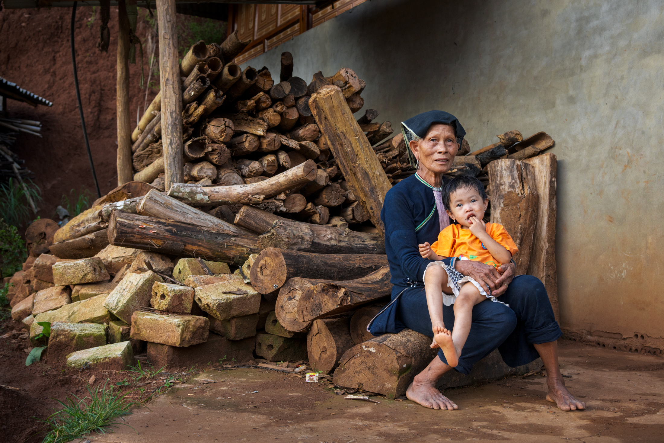 Northern Vietnam Photography: A Photographer’s Journey Beyond the Tourist Trail 22 An elderly woman sits with her grandchild outside a home in a rural village in northern Vietnam.