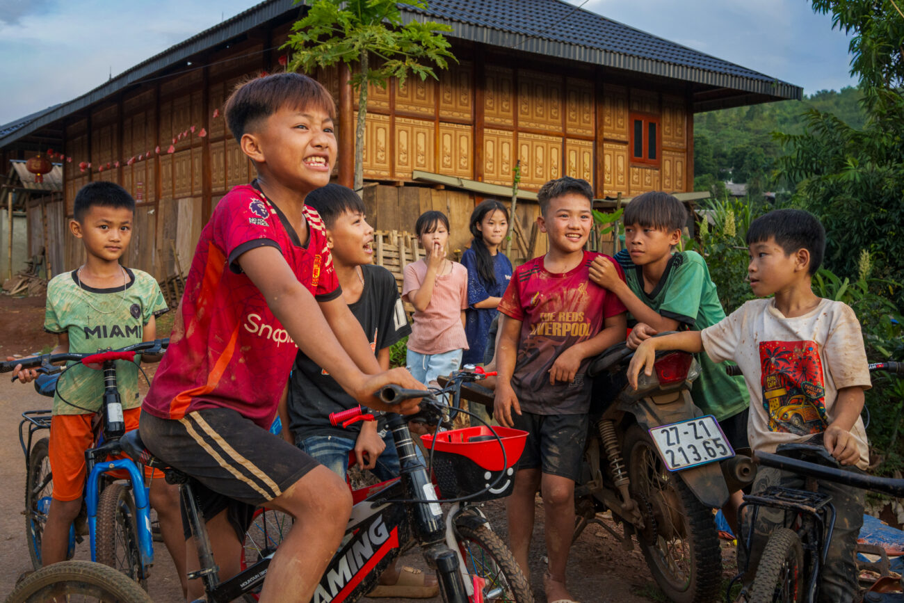 Northern Vietnam Photography: A Photographer’s Journey Beyond the Tourist Trail 6 A group of children gather with bicycles outside a traditional wooden house in a rural village in northern Vietnam.
