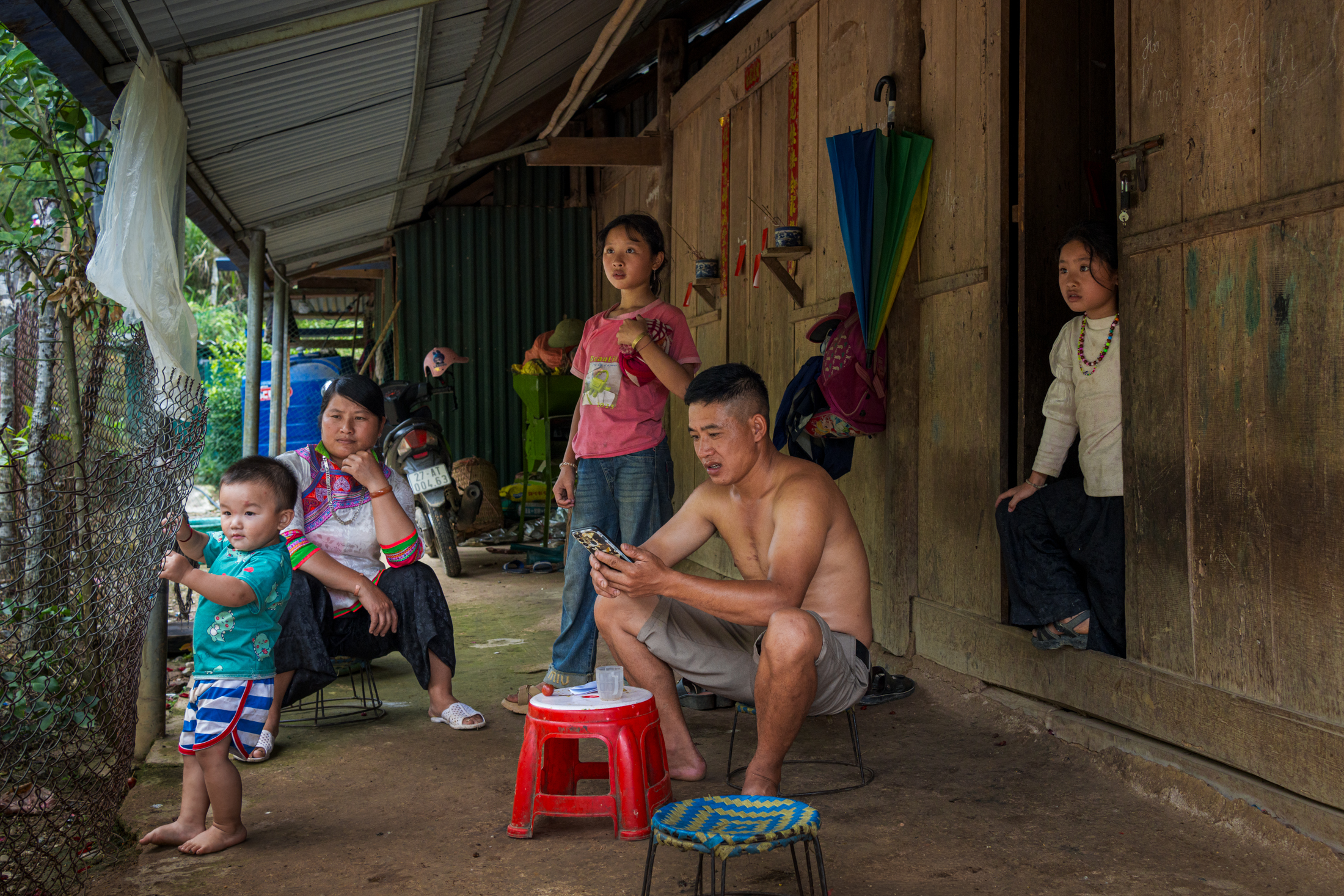 Northern Vietnam Photography: A Photographer’s Journey Beyond the Tourist Trail 28 A family gathers outside a wooden house in a rural village in northern Vietnam.